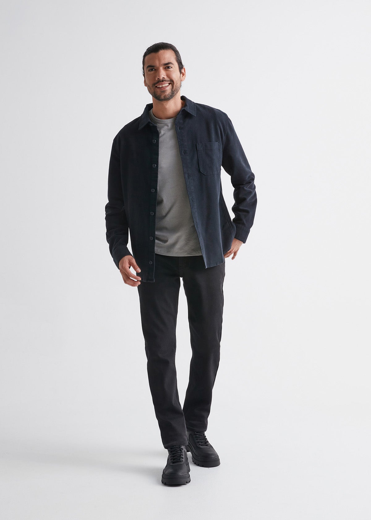 man wearing black slim fit waterproof stretch jeans full body